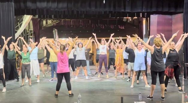 Choreographer Robyn Kent leading the cast in rehearsal Photograph courtesy of Bundaberg Now