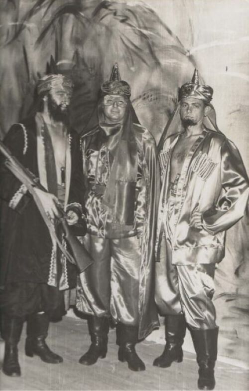 three cast members in costume